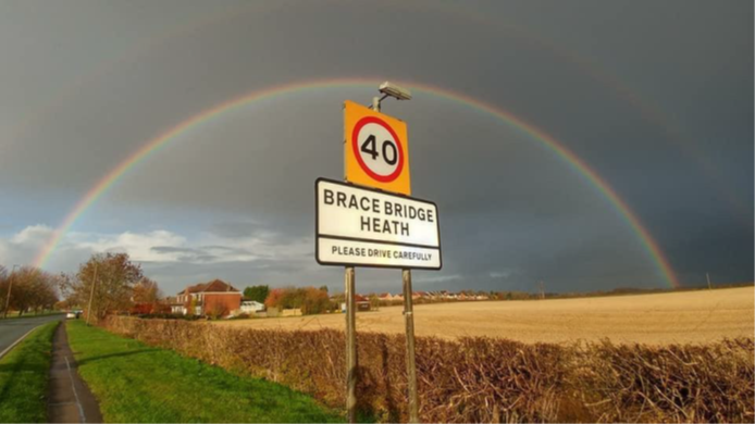 Rainbow over sign